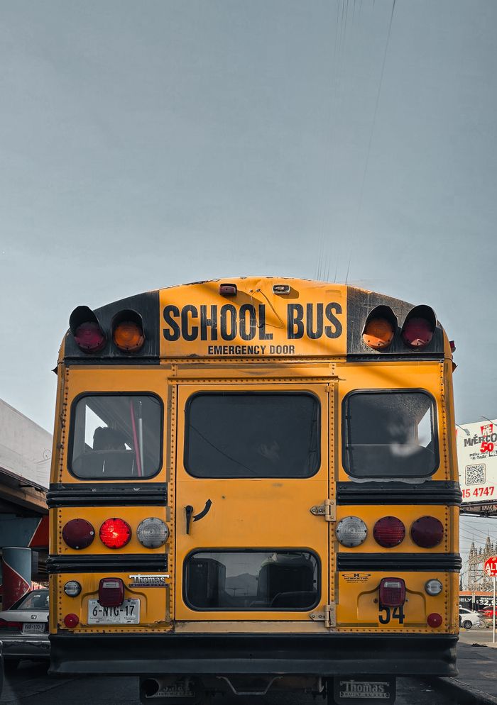 Yellow school bus on a street in San Luis PotosÃ, Mexico, showcasing urban transportation.